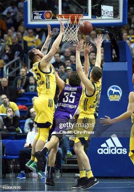 Bogdan Radosavljevic of Alba Berlin, Stephan Haukohl of BG Goettingen and Tim Schneider of Alba Berlin during the Basketball Bundesliga game between...