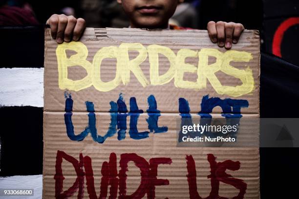 Refugees and migrants in Greece take part in a protest for the International Day for the Elimination of Racial Discrimination in Athens, on March 17,...