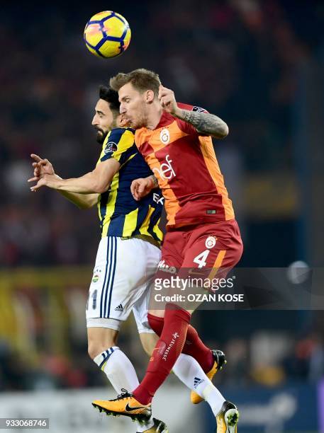 Galatasaray's defender Serdar Aziz heads the ball next to Fenerbahce's defender Hasan Ali Kaldirim during Turkish Spor Toto Super league fotball...