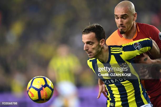 Galatasaray's defender Serdar Aziz heads the ball next to Fenerbahce's defender Hasan Ali Kaldirim during Turkish Spor Toto Super league fotball...