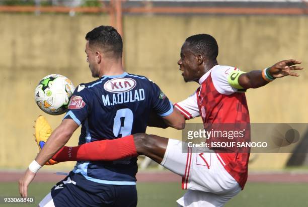Ivory Coast's Romuald Kouassi Diallo vies with Morocco's Mohamed Ahoulad Youssef during the CAF Champions league football match between Williamsville...