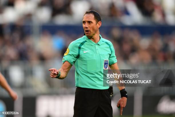 French referee Mikael Lesage gestures during the French L1 football match between Bordeaux and Rennes on March 17 at the Matmut Atlantique Stadium in...