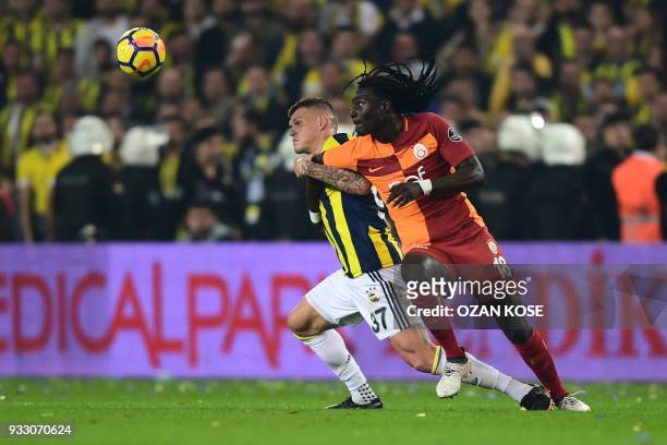 Fenerbahce's defender Martin Skrtel vies for the ball with Galatasaray's Bafetimbi Gomis during Turkish Spor Toto Super league fotball match between...