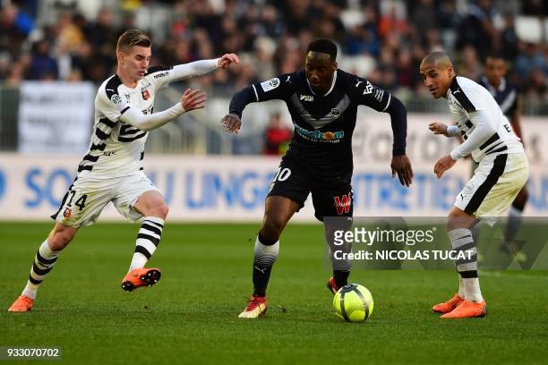 Bordeaux's French midfielder Souahilo Meite vies with Rennes' French midfielder Benjamin Bourigeaud and Rennes' Tunisian midfielder Wahbi Khazri...