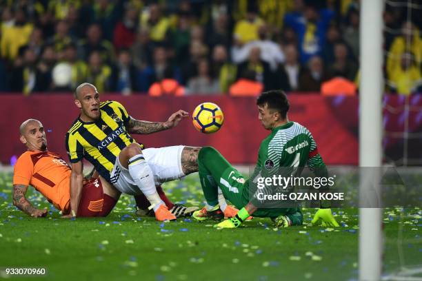 Fenerbahce's Brazilian forward Jose Fernando vies for the ball with Galatasaray's Brazilian defender Maicon and goalkeeper Fernando Muslera during...
