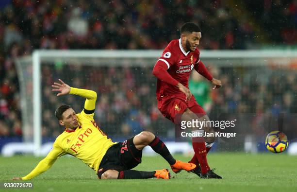 Jose Holebas of Watford and Joe Gomez of Liverpool battle for the ball during the Premier League match between Liverpool and Watford at Anfield on...