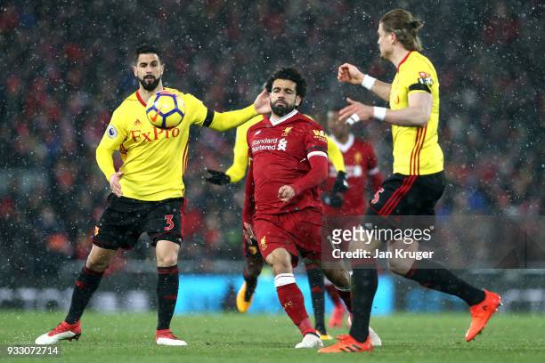 Mohamed Salah of Liverpool is challenged by Miguel Britos of Watford during the Premier League match between Liverpool and Watford at Anfield on...