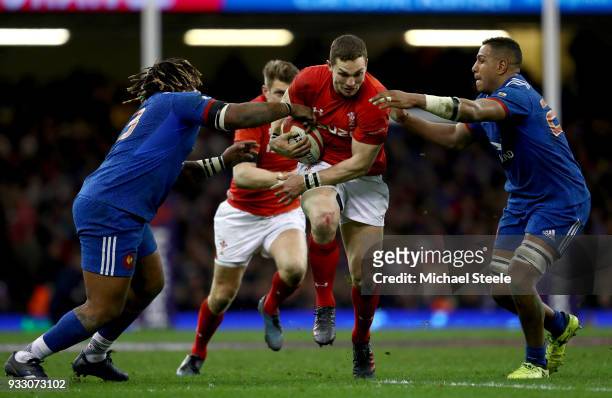 George North of Wales is tackled by Mathieu Bastareaud of France and Mathieu Babillot of France during the NatWest Six Nations match between Wales...