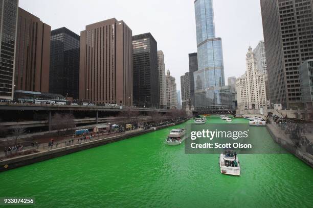 Boats navigate the Chicago River shortly after it was dyed green in celebration of St. Patrick's Day on March 17, 2018 in Chicago, Illinois. Dyeing...