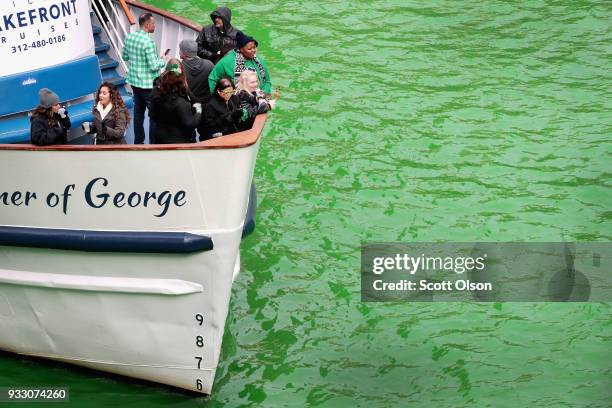 Boat navigates the Chicago River shortly after it was dyed green in celebration of St. Patrick's Day on March 17, 2018 in Chicago, Illinois. Dyeing...
