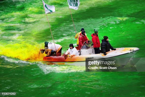 Members of the local plumber's union dye the Chicago River green in celebration of St. Patrick's Day on March 17, 2018 in Chicago, Illinois. Dyeing...