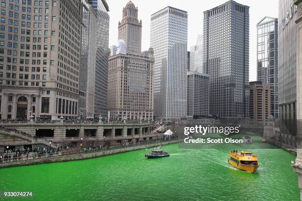 Boats navigate the Chicago River shortly after it was dyed green in celebration of St. Patrick's Day on March 17, 2018 in Chicago, Illinois. Dyeing...