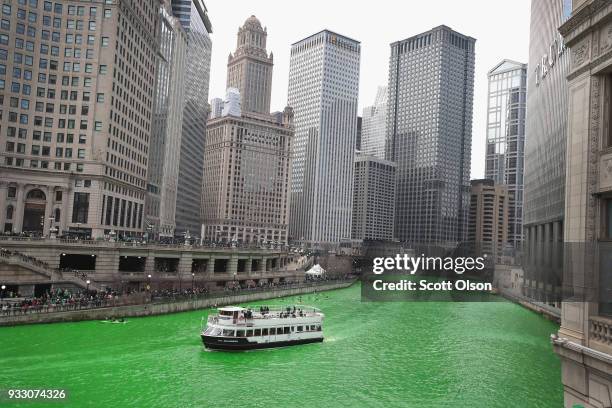 Boat navigates the Chicago River shortly after it was dyed green in celebration of St. Patrick's Day on March 17, 2018 in Chicago, Illinois. Dyeing...