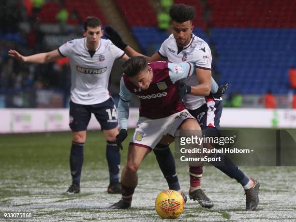 Aston Villa's Jack Grealish and Bolton Wanderers' Derik Osede during the Sky Bet Championship match between Bolton Wanderers and Aston Villa at...