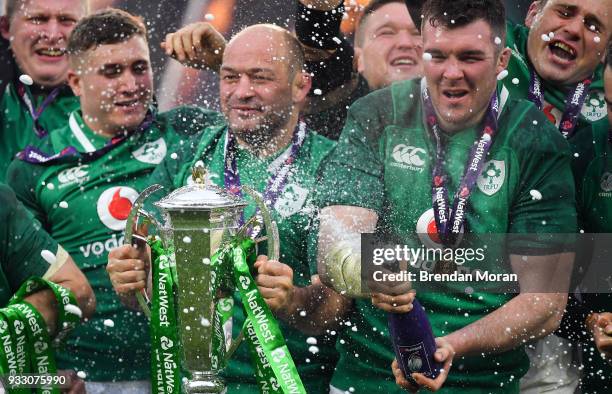 London , United Kingdom - 17 March 2018; Ireland players, from left, Jordan Larmour, Rory Best and Peter O'Mahony celebrate with the trophy after the...