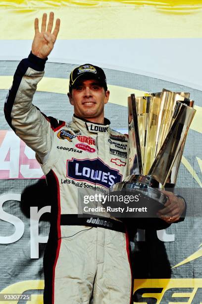 Jimmie Johnson, driver of the Lowe's Chevrolet, celebrates with the trophy after winning the NASCAR Sprint Cup Series Championship after finishing in...