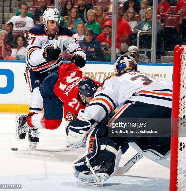Milan Lucic of the Edmonton Oilers upends Vincent Trocheck of the Florida Panthers at the BB&T Center on March 17, 2018 in Sunrise, Florida.