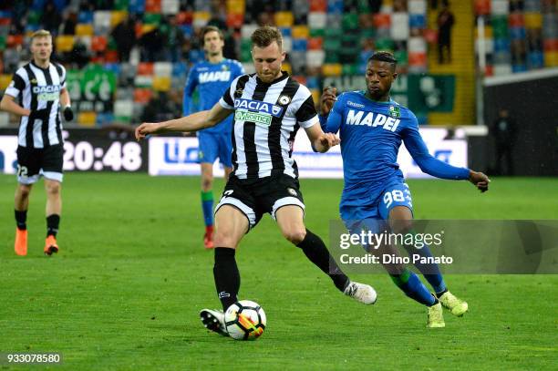 Silvan Widmer of Udinese competes with Claud Adjapong of Sassuolo during the serie A match between Udinese Calcio and US Sassuolo at Stadio Friuli on...