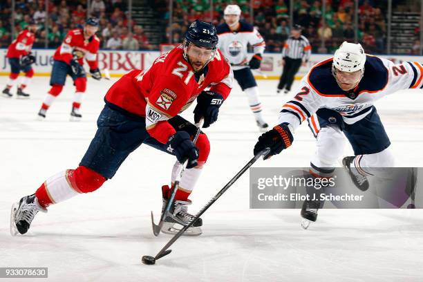 Andrej Sekera of the Edmonton Oilers poke checks Vincent Trocheck of the Florida Panthers during first period action at the BB&T Center on March 17,...