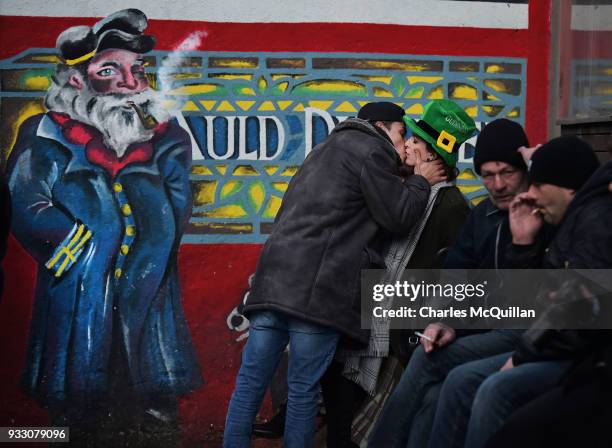 Woman kisses a stranger in the street in Temple Bar after the annual Saint Patrick's day parade takes place on March 17, 2018 in Dublin, Ireland....