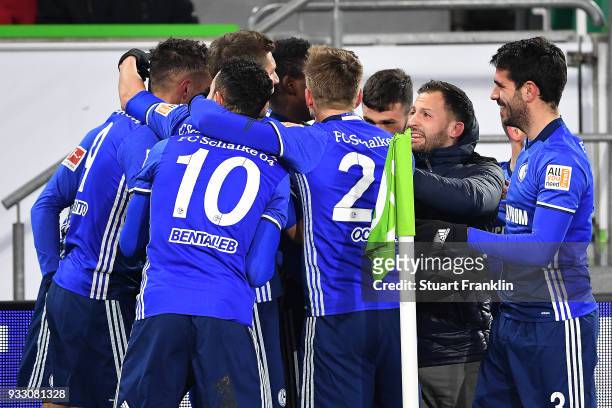 Players of Schalke celebrate an own goal by Robin Knoche of Wolfsburg to make it 0:1 during the Bundesliga match between VfL Wolfsburg and FC Schalke...