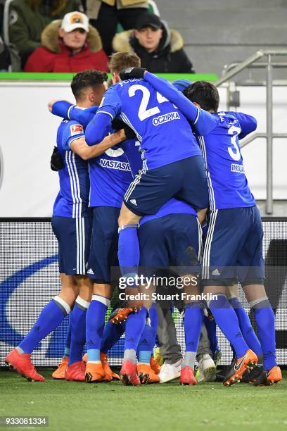 Players of Schalke celebrate an own goal by Robin Knoche of Wolfsburg to make it 0:1 during the Bundesliga match between VfL Wolfsburg and FC Schalke...