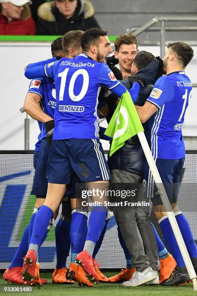 Players of Schalke celebrate an own goal by Robin Knoche of Wolfsburg to make it 0:1 during the Bundesliga match between VfL Wolfsburg and FC Schalke...