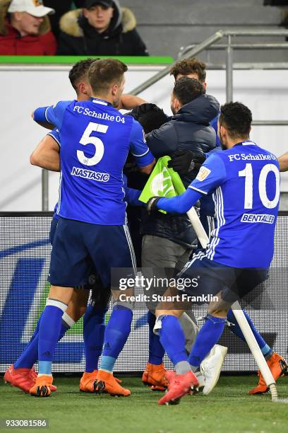 Players of Schalke celebrate an own goal by Robin Knoche of Wolfsburg to make it 0:1 during the Bundesliga match between VfL Wolfsburg and FC Schalke...