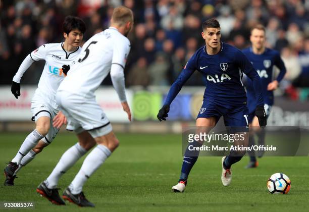 Erik Lamela of Tottenham Hotspur in action with Mike van der Hoorn Ki Sung-yueng of Swansea City during the Emirates FA Cup Quarter Final match...