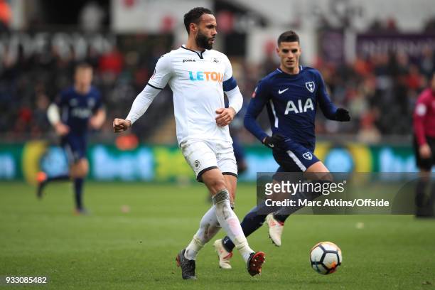 Kyle Bartley of Swansea City in action with Erik Lamela of Tottenham Hotspur during the Emirates FA Cup Quarter Final match between Swansea City and...