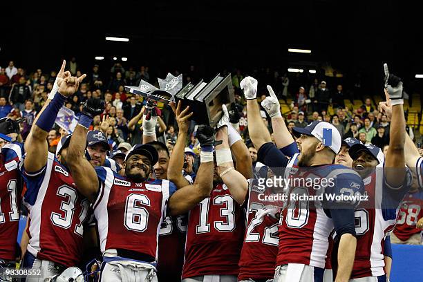 Members of the Montreal Alouettes hoist the Eastern Final Trophy while celebrating their 56-18 victory over the B.C Lions during the Eastern Finals...