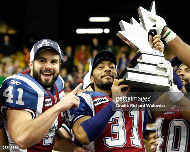 Mark Estelle of the Montreal Alouettes hoists the Eastern Final Trophy after defeating the B.C Lions 56-18 during the Eastern Finals at Olympic...