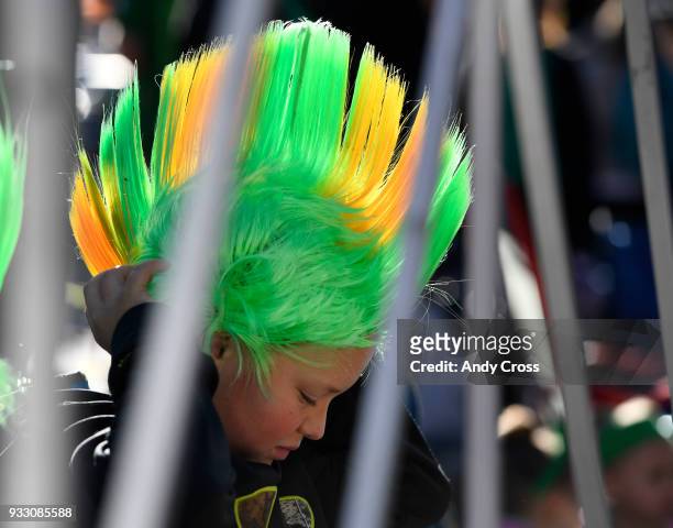 Ayden Bateman adjusts his St. Patrick's Day mohawk at the beginning of the annual St. Patrick's parade in downtown Denver March 17, 2018.