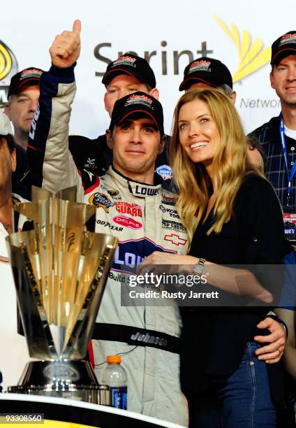 Jimmie Johnson , driver of the Lowe's Chevrolet, poses with his wife Chandra after winning the NASCAR Sprint Cup Series Championship after finishing...