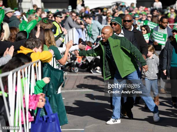 Denver Mayor Michael Hancock greets parade goers at the start of the annual St. Patrick's parade in downtown Denver March 17, 2018.