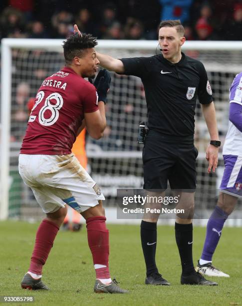 Referee Ben Toner waves away the protest of Hildeberto Pereira of Northampton Town during the Sky Bet League One match between Northampton Town and...