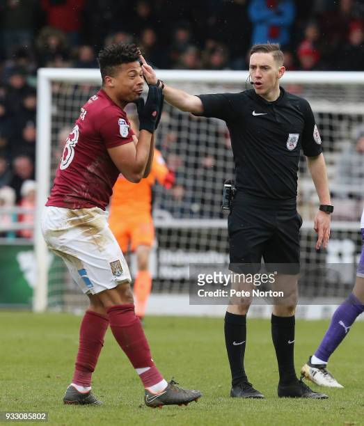 Referee Ben Toner waves away the protest of Hildeberto Pereira of Northampton Town during the Sky Bet League One match between Northampton Town and...