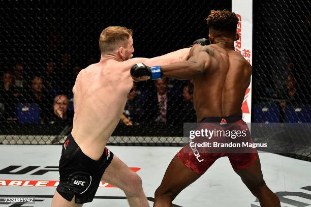 Danny Henry of Scotland punches Hakeem Dawodu in their featherweight bout inside The O2 Arena on March 17, 2018 in London, England.