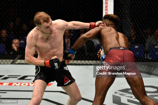 Danny Henry of Scotland punches Hakeem Dawodu in their featherweight bout inside The O2 Arena on March 17, 2018 in London, England.