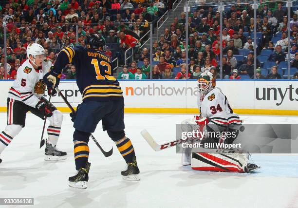 Nicholas Baptiste of the Buffalo Sabres deflects the game-winning third period goal against J-F Berube of the Chicago Blackhawks during an NHL game...