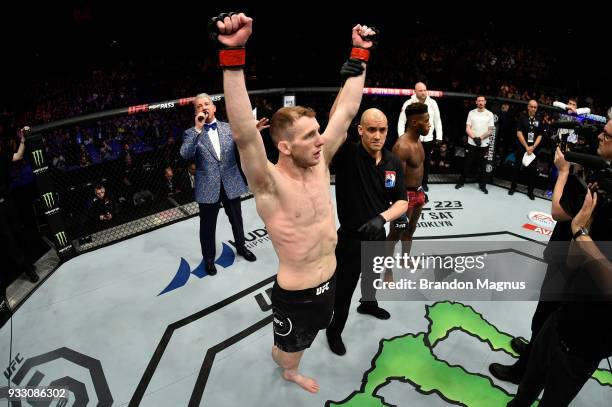 Danny Henry of Scotland celebrates after defeating Hakeem Dawodu by submission in their featherweight bout inside The O2 Arena on March 17, 2018 in...