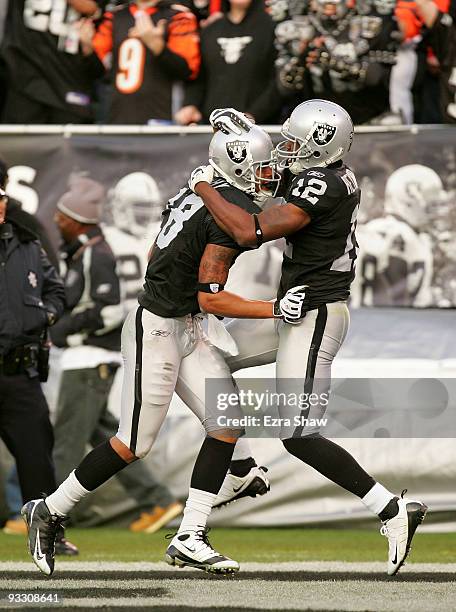 Louis Murphy of the Oakland Raiders is congratulated by Darrius Heyward-Bey after Murphy scored the tying touchdown against the Cincinnati Bengals at...