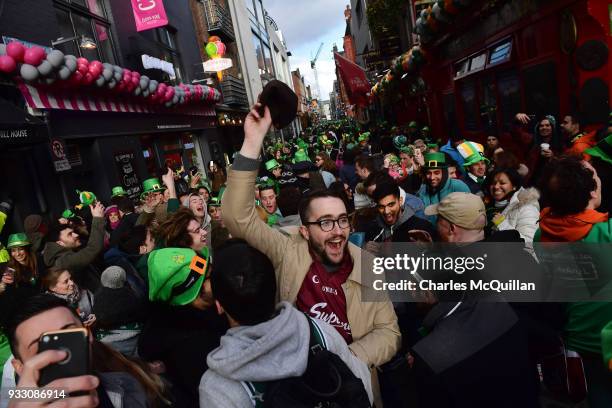 Ireland rugby fans celebrate after the final whistle in Temple bar as Ireland defeat England in the Six Nations rugby championship on March 17, 2018...