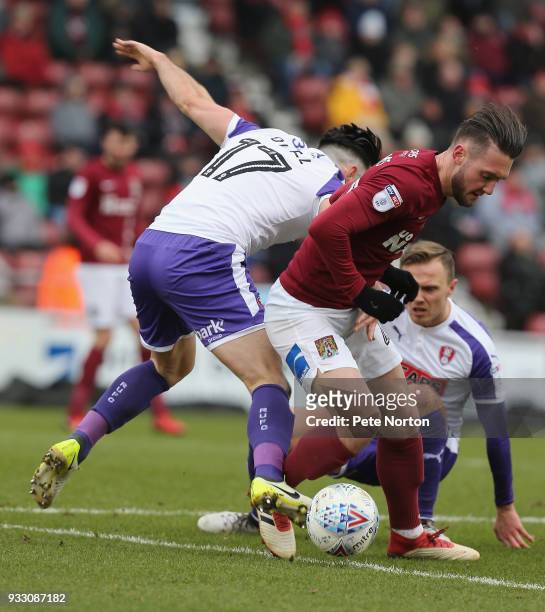 Matt Grimes of Northampton Town controls the ball under pressure from Richie Towell of Rotherham United during the Sky Bet League One match between...