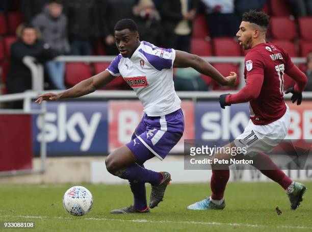 Josh Emmanuel of Rotherham United moves with the ball away from Daniel Powell of Northampton Town during the Sky Bet League One match between...