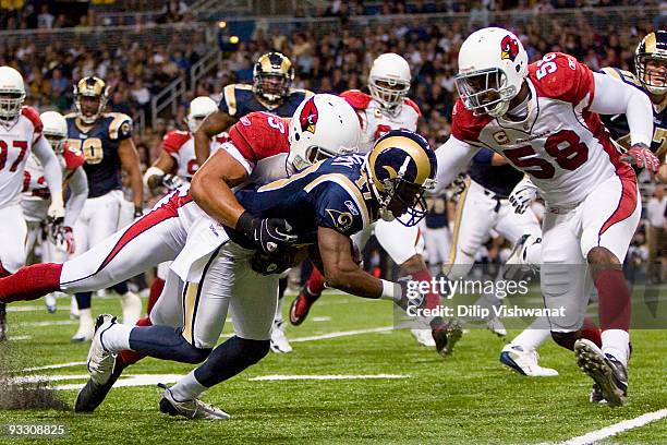 Clark Haggans and Karlos Dansby both of the Arizona Cardinals tackle Donnie Avery of the St. Louis Rams at the Edward Jones Dome on November 22, 2009...