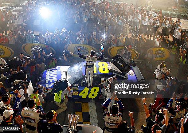 Jimmie Johnson, driver of the Lowe's Chevrolet, celebrates after winning the NASCAR Sprint Cup Series Championship after finishing in fifth place in...