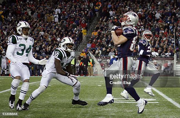Wes Welker of the New England Patriots catches a punt as Wallace Wright and Marquis Cole of the New York Jets defend on November 22, 2009 at Gillette...