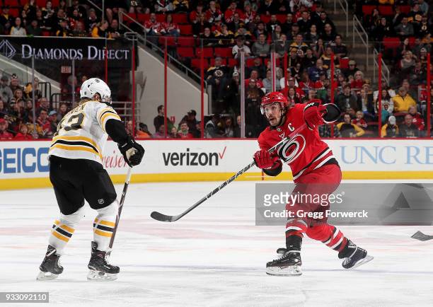 Justin Faulk of the Carolina Hurricanes shoots the puck during an NHL game against the Boston Bruins on March 13, 2018 at PNC Arena in Raleigh, North...