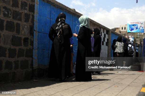 Yemeni artists draw graffiti during an Open Day of graffiti campaign call for peace on March 15, 2018 in Sana'a, Yemen.